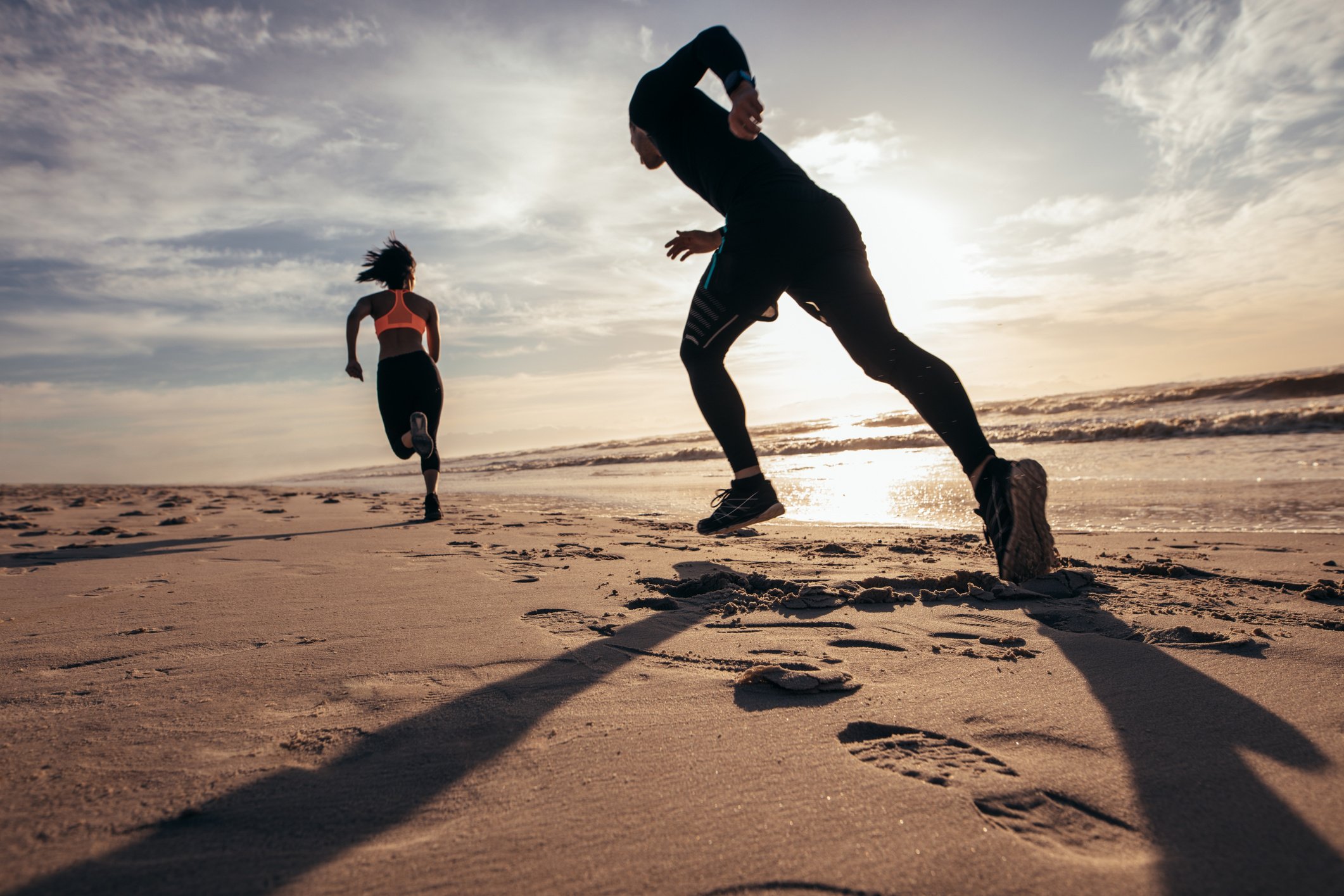 Fit People Sprinting on the Beach